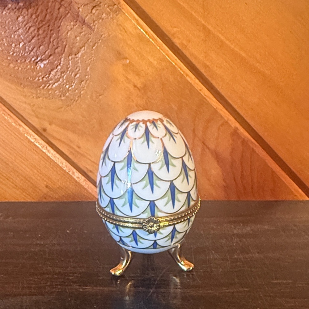Elegant Gold and White Decorative Egg with Green Accents